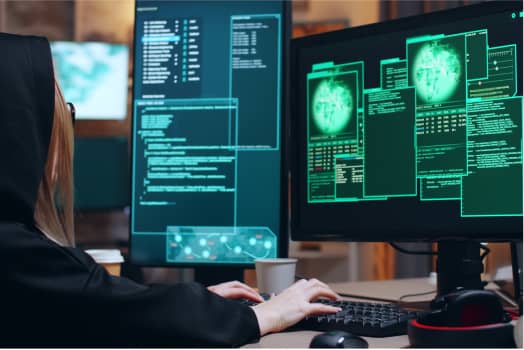 A woman with two monitor with terminal on the screens